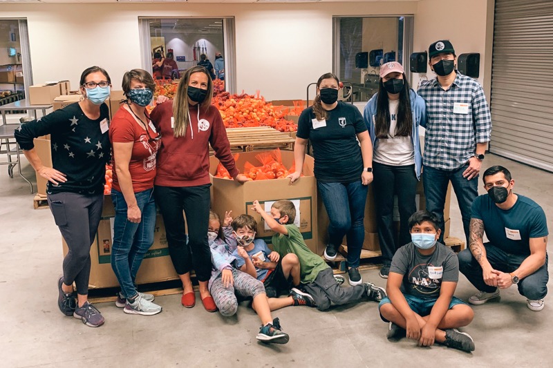 San Diego Public Defender group poses for photo in Feeding San Diego's distribution center after volunteering