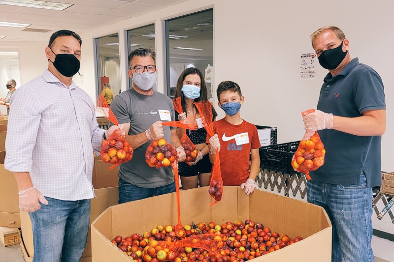Johnson Fistel group poses in Feeding San Diego's volunteer center