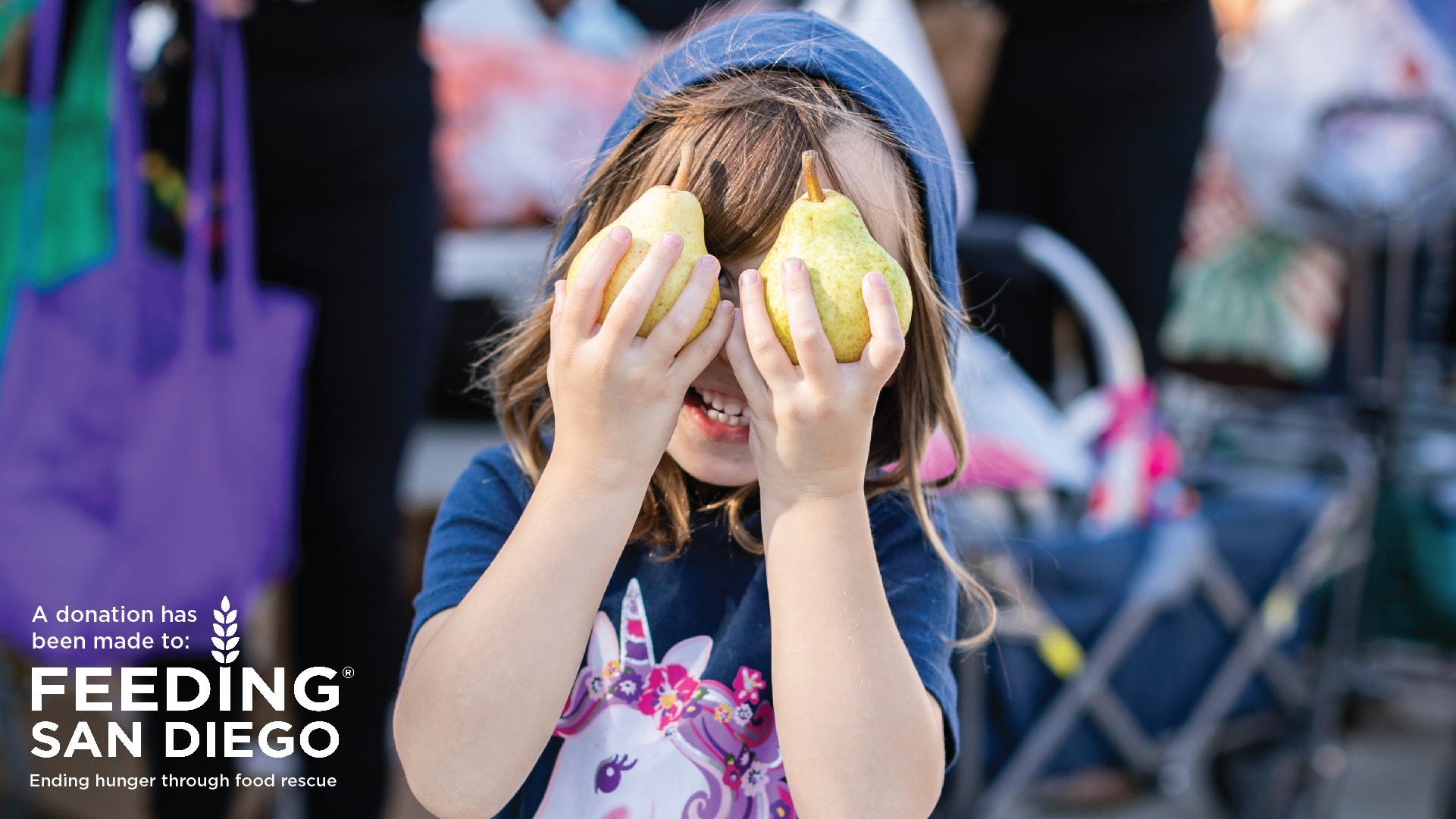 An e-card with a photo of a girl holding pears over her eyes and text that reads A donation has been made to Feeding San Diego