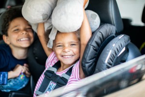 Kids in back seat of car at Feeding San Diego food distribution, one of our Feeding San Diego programs.