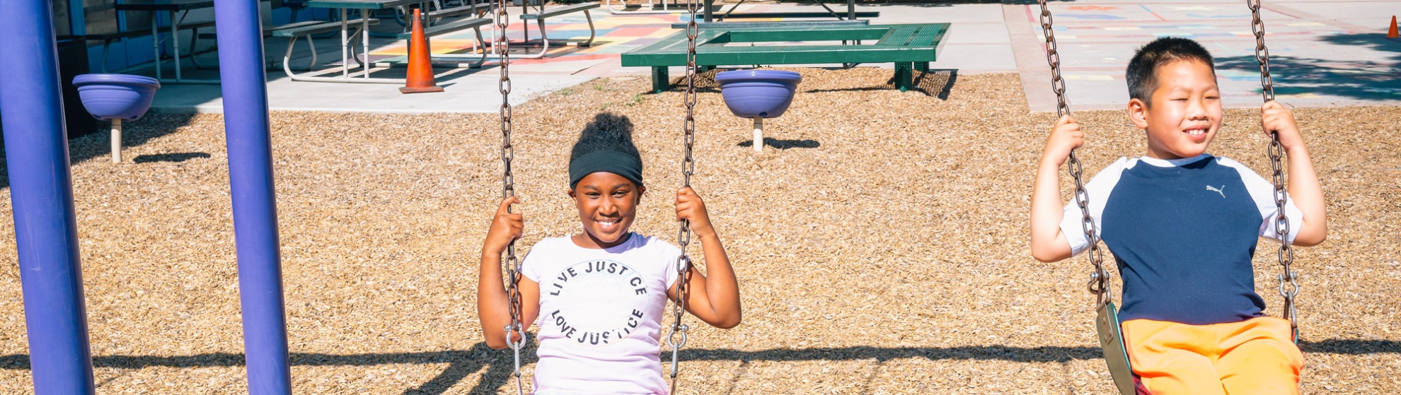 Kids swing on swings at the playground