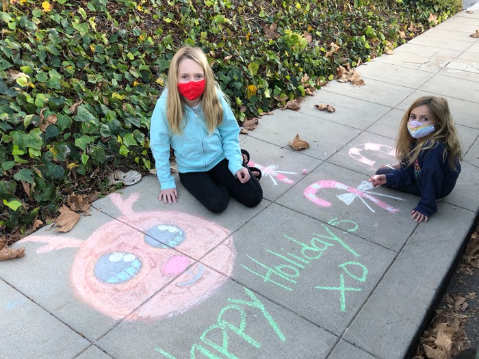 Two girls chalk their block to end hunger in San Diego County as part of a Feeding San Diego fundraising opportunity