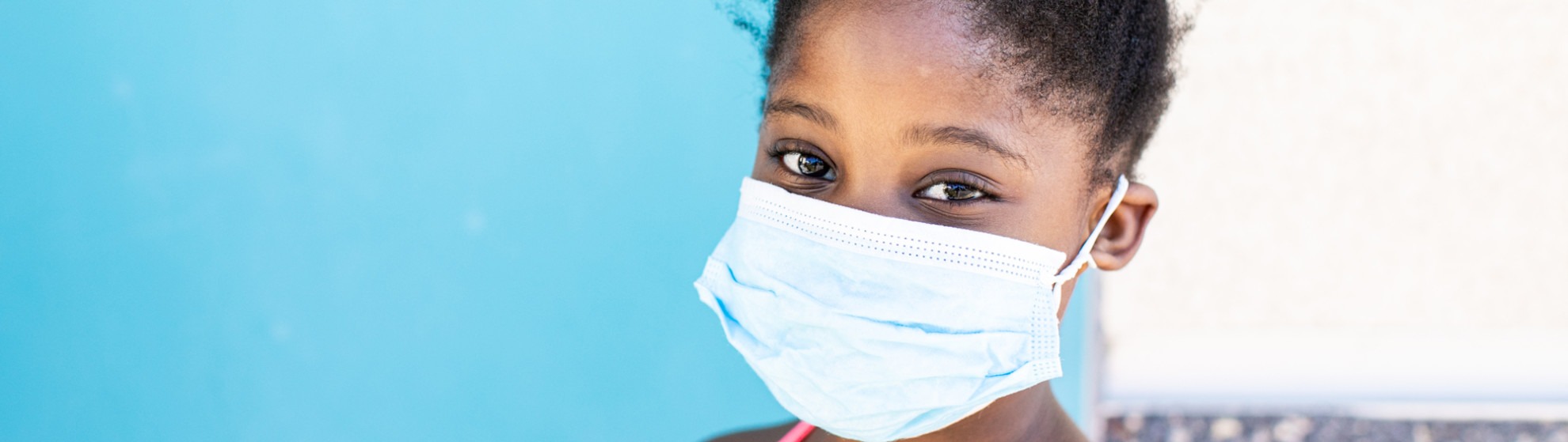 Girl with mask on at Feeding San Diego food distribution