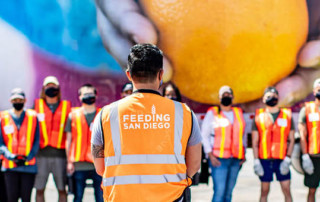 Volunteers standing in front of a Feeding San Diego truck