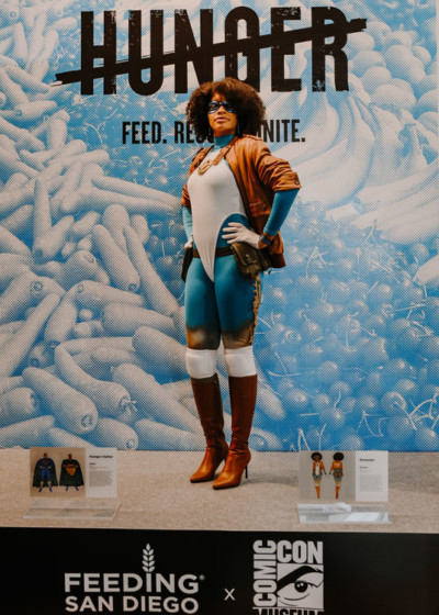A woman in a superhero costume standing on a podium