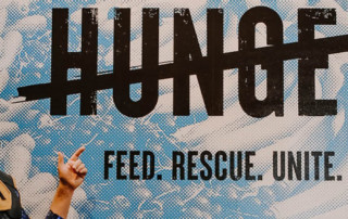 Hunger Action Heroes point to Cross Out Hunger sign