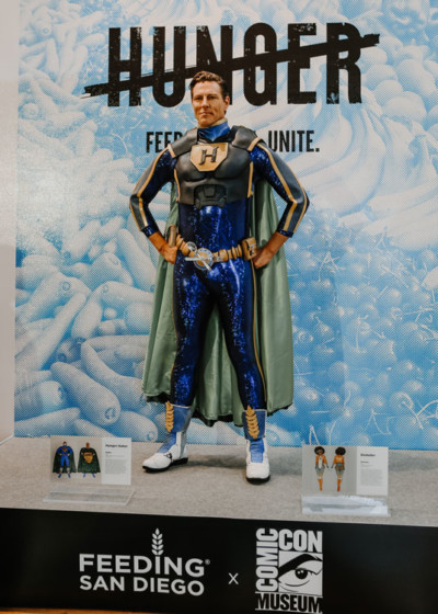 A man in a superhero costume standing on a podium