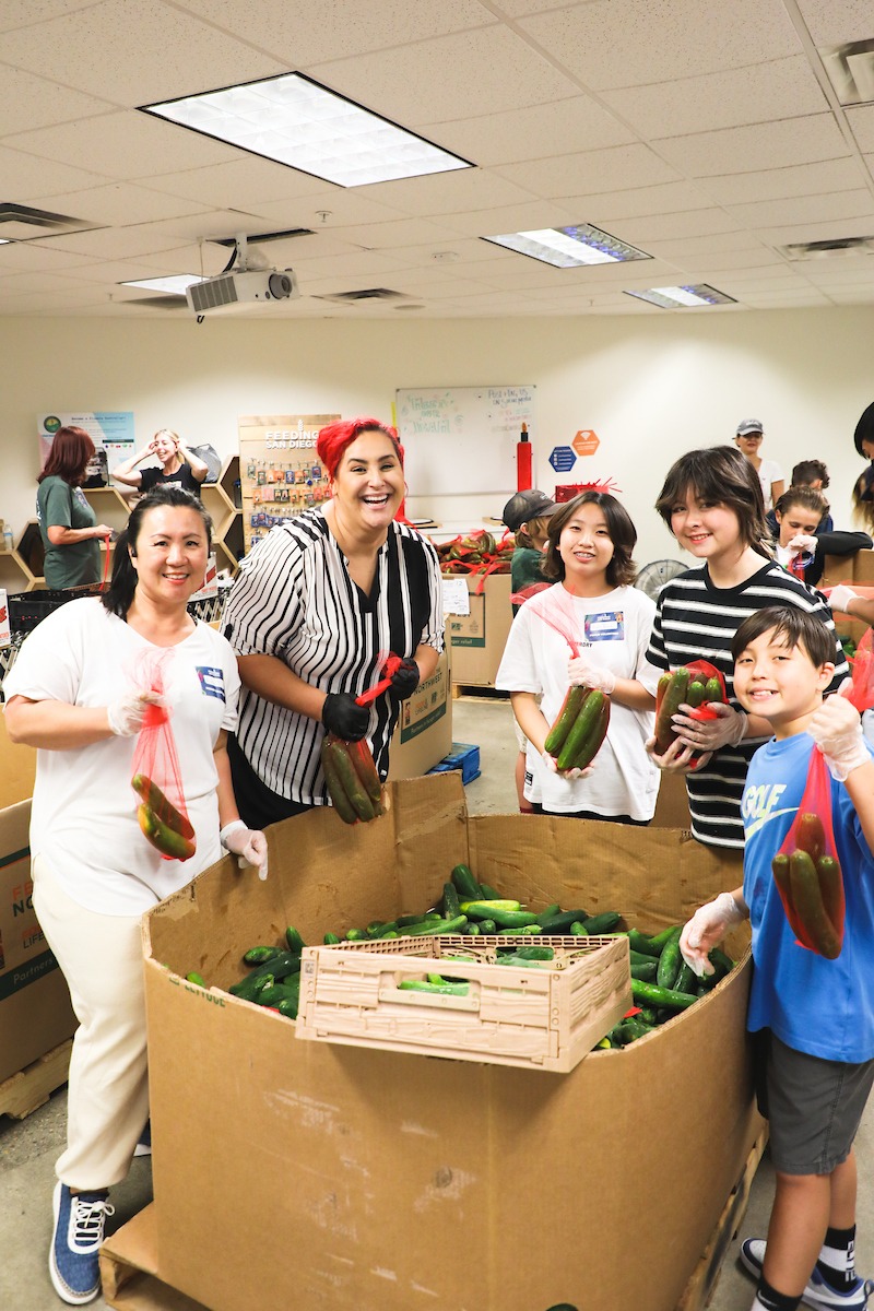 Chef Claudia volunteers with friends at Feeding San Diego's distribution center