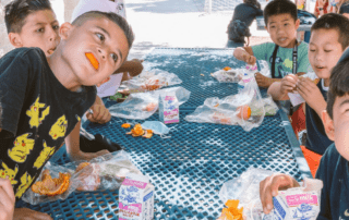 A group of kids eating lunch and making silly faces