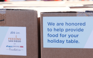 Two boxes with stickers reading "We are honored to help provide food for your holiday table."