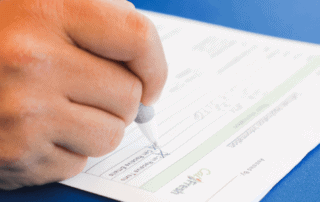 Close up of someone filling out a CalFresh application