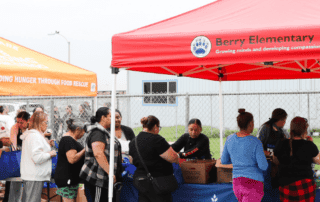 Community members lined up to receive food at the Berry Elementary school food pantry