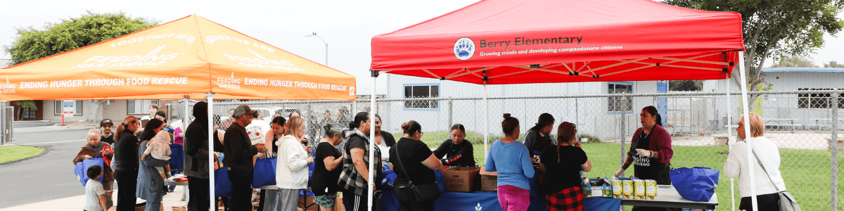 Community members lined up to receive food at the Berry Elementary school food pantry