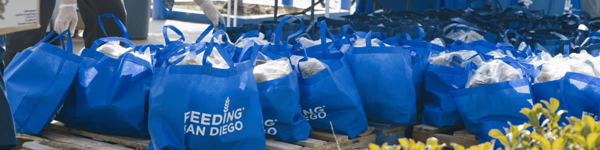 Blue Feeding San Diego bags filled with food waiting to be distributed to the community