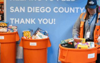 A Feeding San Diego employee sorts through food from a food drive
