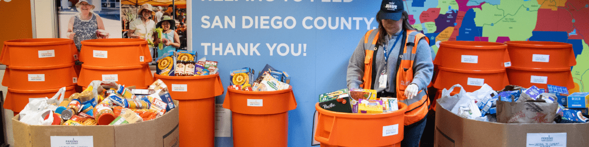 A Feeding San Diego employee sorts through food from a food drive