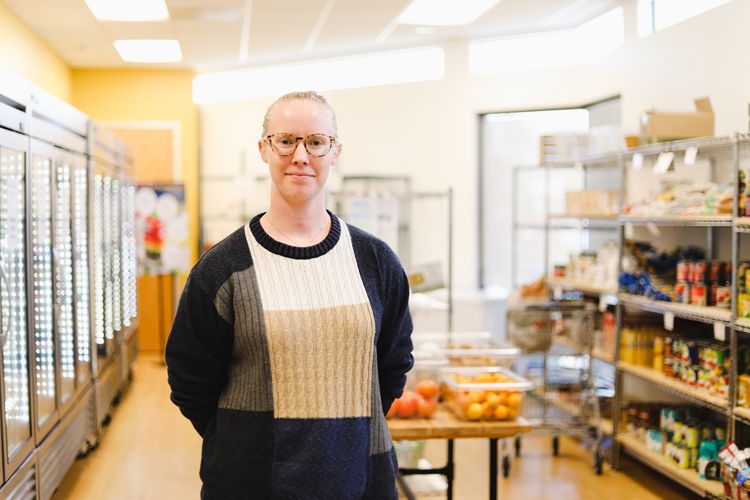 A woman standing in a market aisle