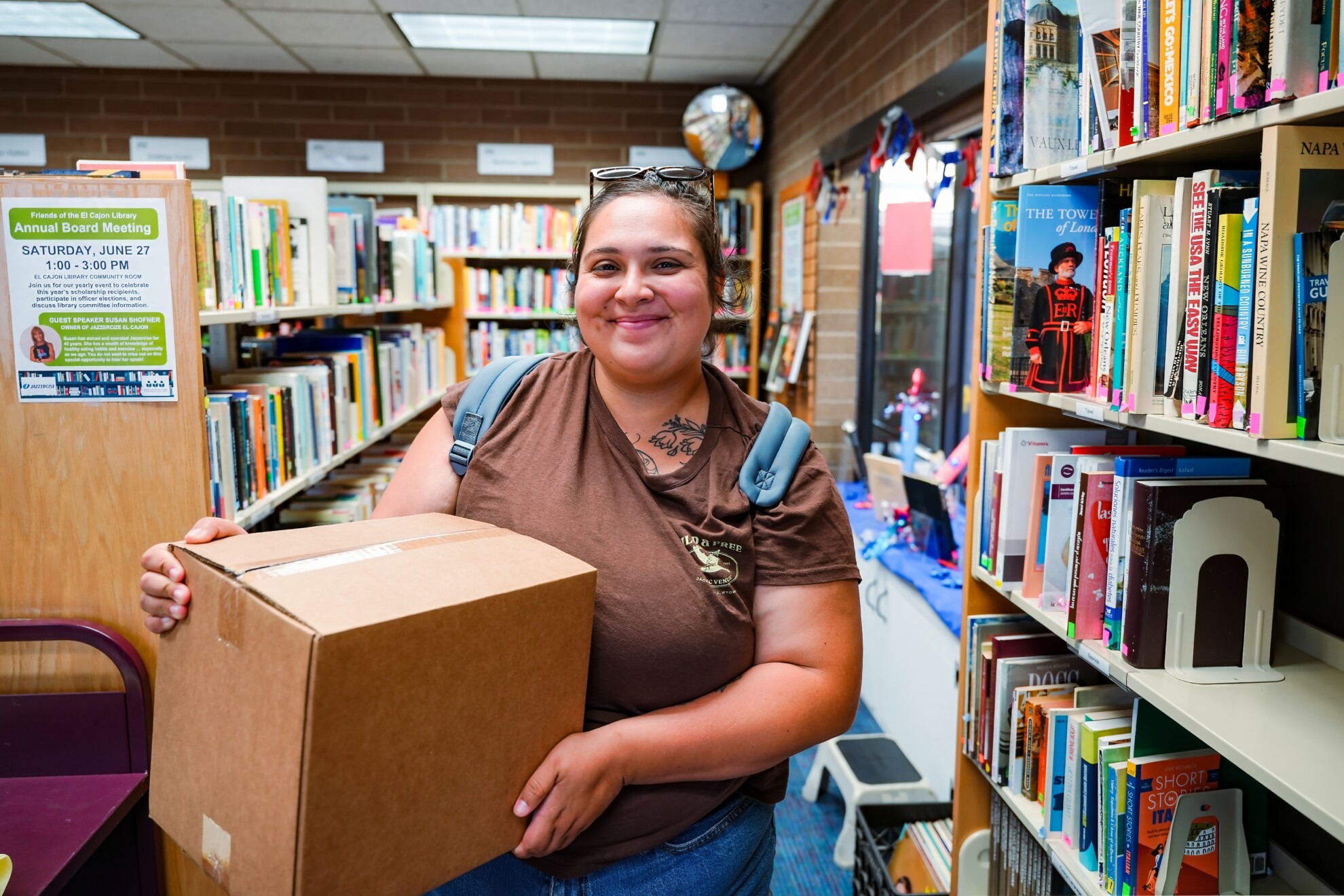 Woman holding a box of food in a library